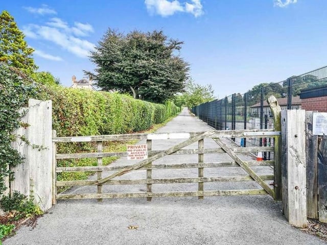 The sweeping, private driveway that leads to the property. It also leads to a large standing area, suitable for the parking of many vehicles.
