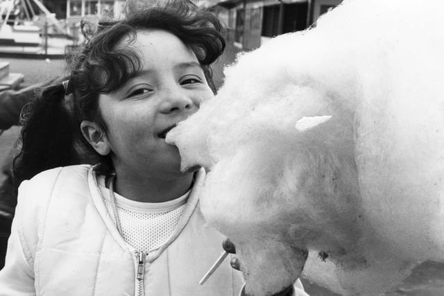 Leanne Urwin, 8, tucks into candy floss at the fairground in 1983.
