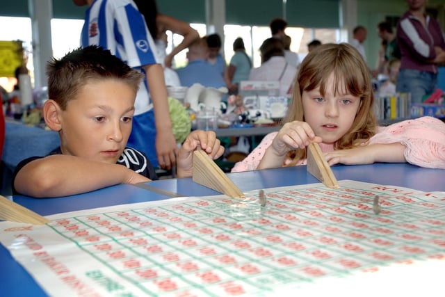 A firm favourite at the Rift House Primary School summer fair in 2005 as these children trying out the roll a penny stand.