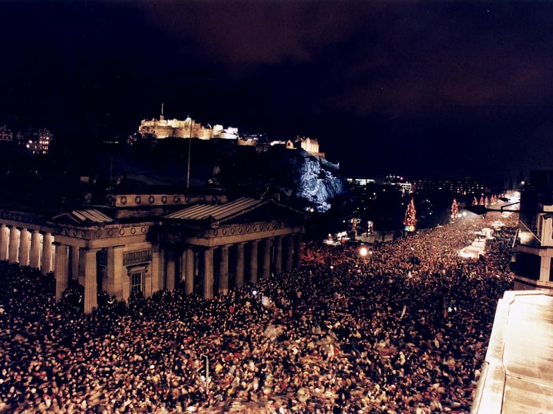 Revellers celebrating New Year on Princes street at The Mound with Edinburgh Castle in the background. There were a reported 400,000 people in attendance.