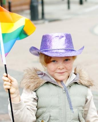 Bethany Simmons aged eight holding a pride flag in 2007.