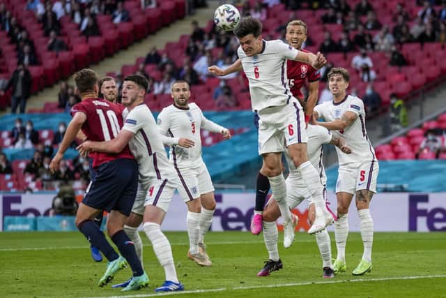 England's Harry Maguire heads the ball during the Euro 2020 soccer championship group D match between Czech Republic and England at Wembley. (AP Photo/Frank Augstein, Pool)