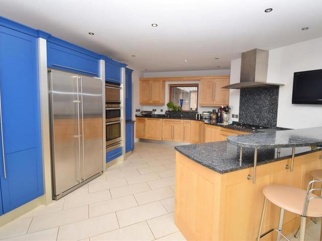 Another shot of the kitchen which shows the American-style fridge-freezer and pull-out pantry cupboards. There is also a stainless-steel one-and-a-half electric oven, warming drawer and steam oven, integrated dishwasher and wine rack.