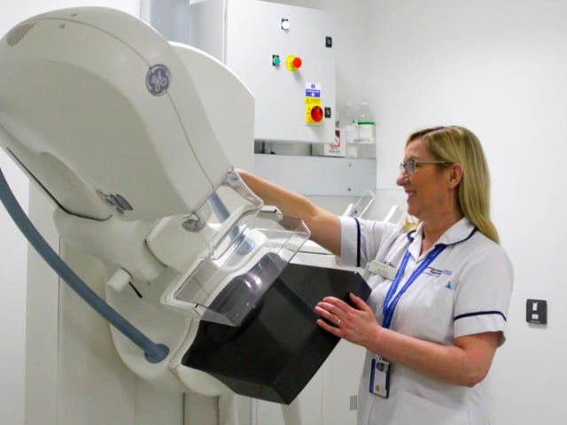 Senior radiographer Julia Yemm preparing to do a breast screening.