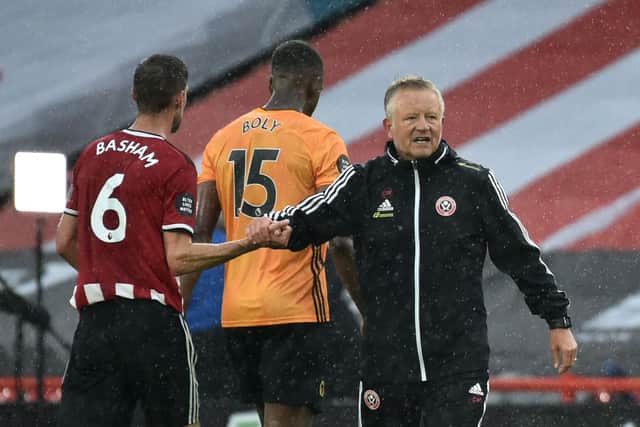 Chris Wilder congratulates Sheffield United's English defender Chris Basham at the end of the English Premier League football match between Sheffield United and Wolverhampton Wanderers (Photo by Rui Vieira / POOL / AFP)