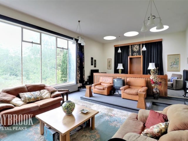 The living room boasts original features from the former court house.