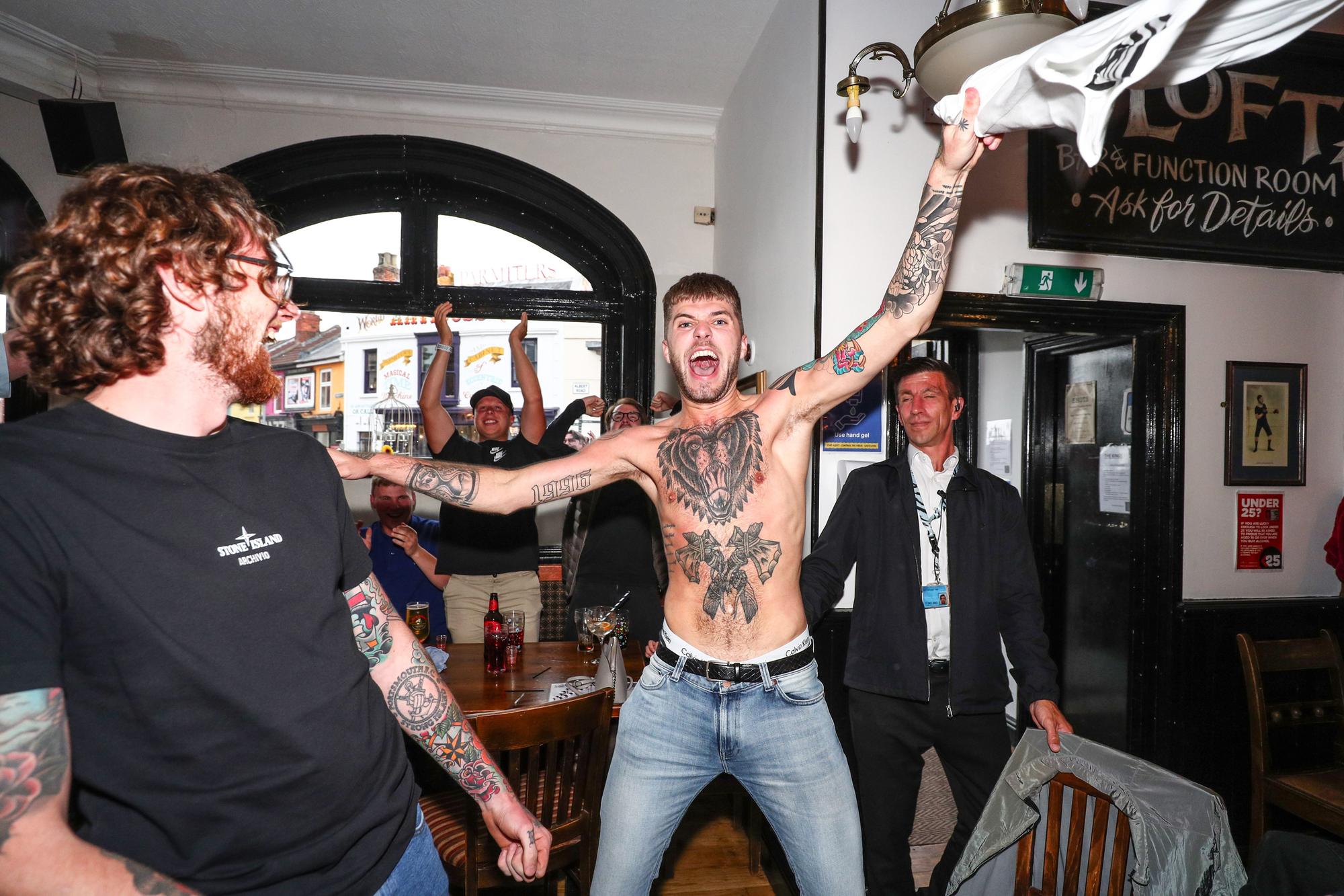 Fans pictured in The Kings pub celebrating as England score their first goal. Picture: Stuart Martin (220421-7042)