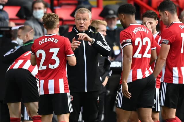 Sheffield United's manager Chris Wilder (C) speaks with his players during a drinks break in the English Premier League football match between Sheffield United and Chelsea at Bramall Lane: SHAUN BOTTERILL/POOL/AFP via Getty Images