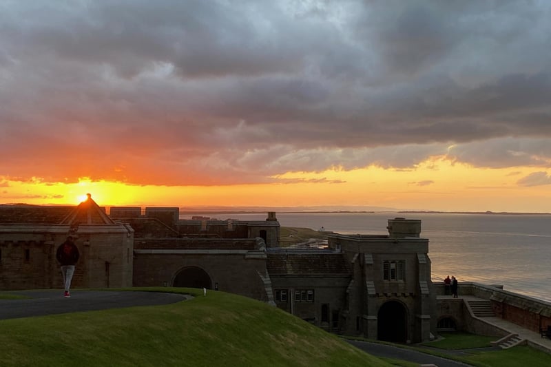 The sun sets on a magnificent scene looking towards Lindisfarne Castle (on the horizon to the right of the picture) from inside Bamburgh Castle on Friday, August 13.