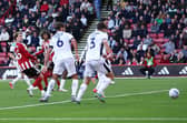 Decisive blow: Patrick Bamford, left, steers Sheffield United in front through a sea of Lincoln City legs (Picture: Jake Youle / Sportimage)