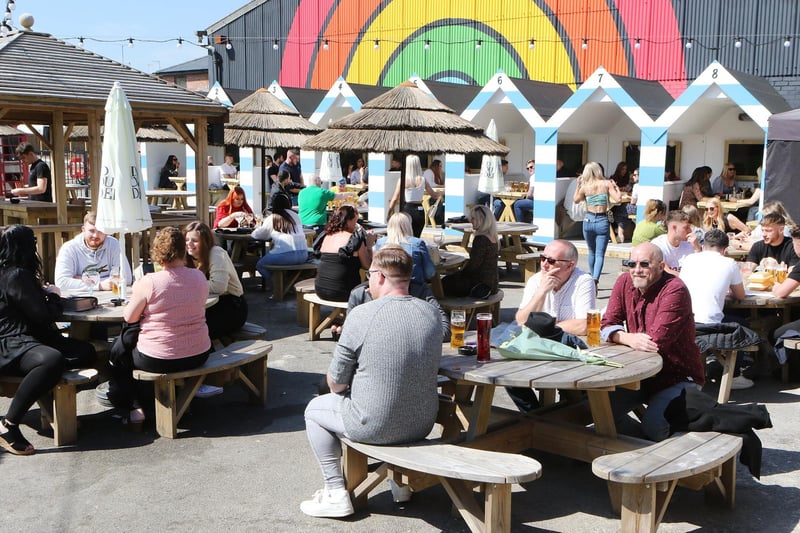 The pub beer garden is overlooked by a mural celebrating NHS heroes.