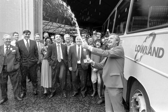 Lowland Scottish Omnibuses' boss Douglas Pelling breaks open the champagne to celebrate with staff at the news they are the first bus company to be privatised in June 1990.