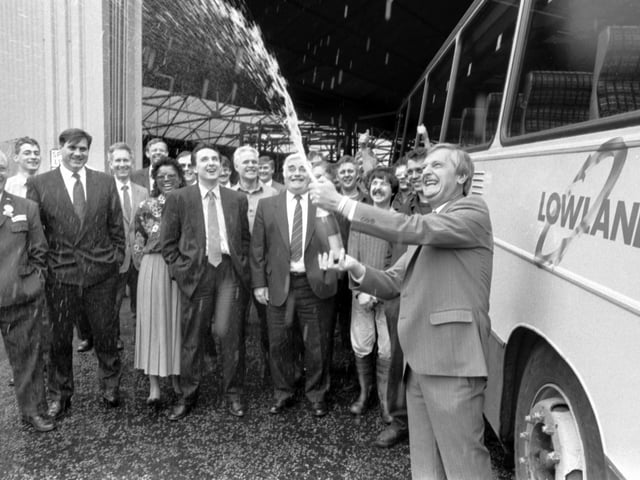 Lowland Scottish Omnibuses' boss Douglas Pelling breaks open the champagne to celebrate with staff at the news they are the first bus company to be privatised in June 1990.