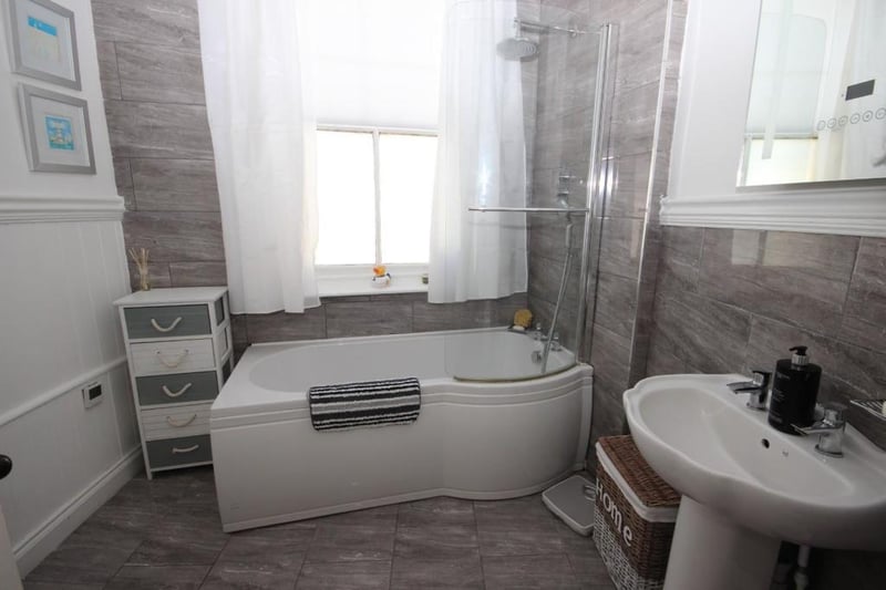 The family bathroom is fitted with three piece white suite.
