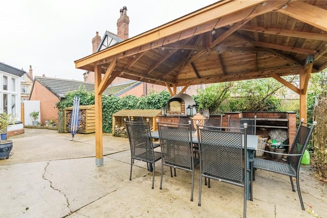 The sheltered pergola, complete with pizza oven and barbecue, at the rear of the property.