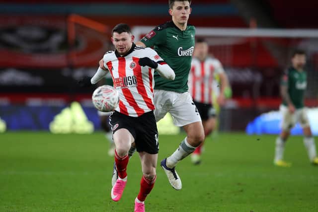 Plymouth Argyle's Keeland Watts with Oliver Burke of Sheffield United: Simon Bellis/Sportimage