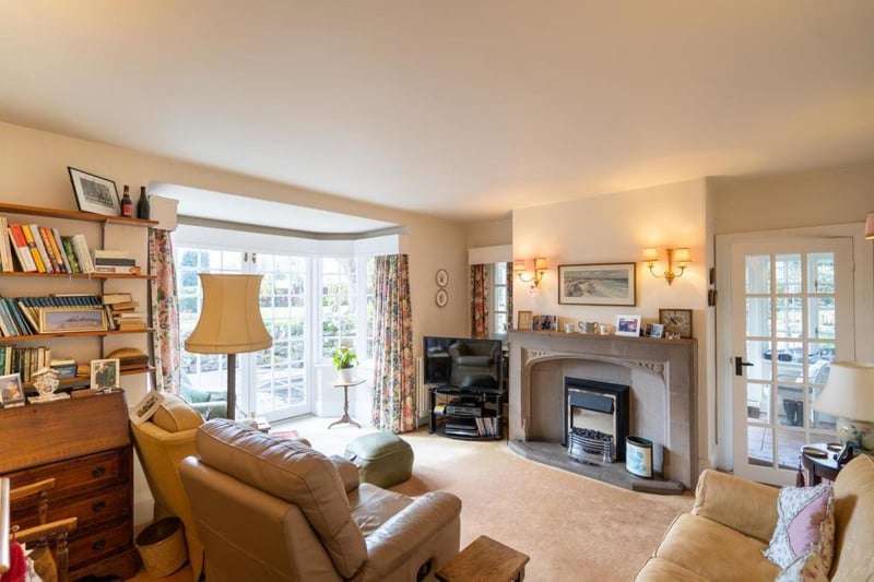 The cosy living room features french doors opening to the rear garden.