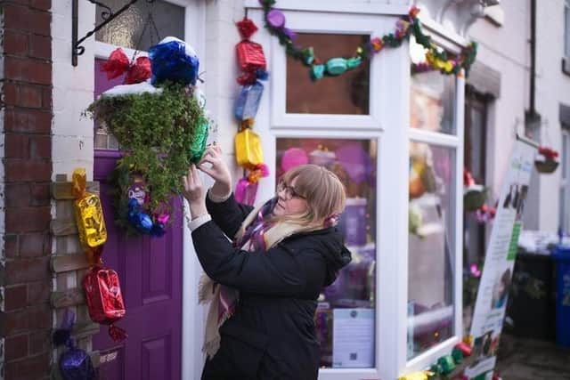Kayleigh Thomas, from Sheffield, puts the finishing touches to her Quality Street decorations (Photo: SWNS)