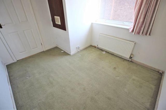 The third bedroom is small, but there is still room for a storage cupboard that houses the property's boiler. The room has a carpeted floor, decorative ceiling-light, radiator and window to the side of the house.
