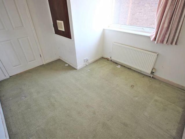 The third bedroom is small, but there is still room for a storage cupboard that houses the property's boiler. The room has a carpeted floor, decorative ceiling-light, radiator and window to the side of the house.
