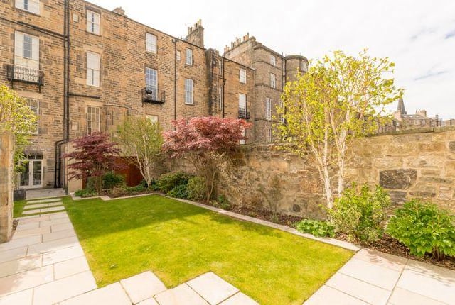 The property boasts a private walled garden and double garage to the rear