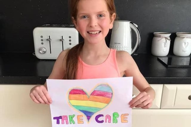 A beaming Freya, aged nine, and her caring message.