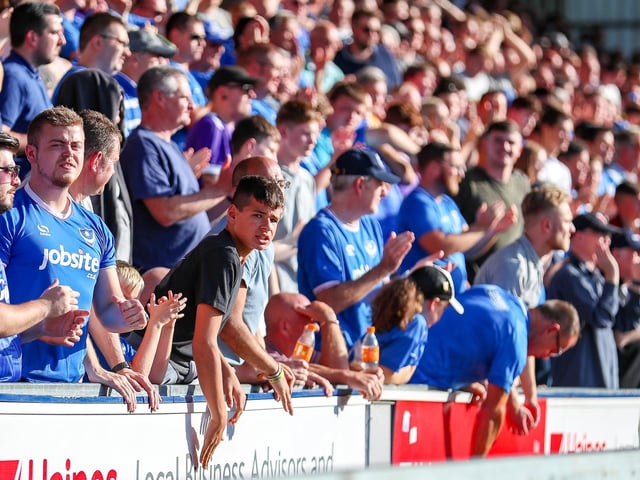 These Pompey fans, among the 2.125, who made it to AFC Wimbledon back in October attempt to lift the players.