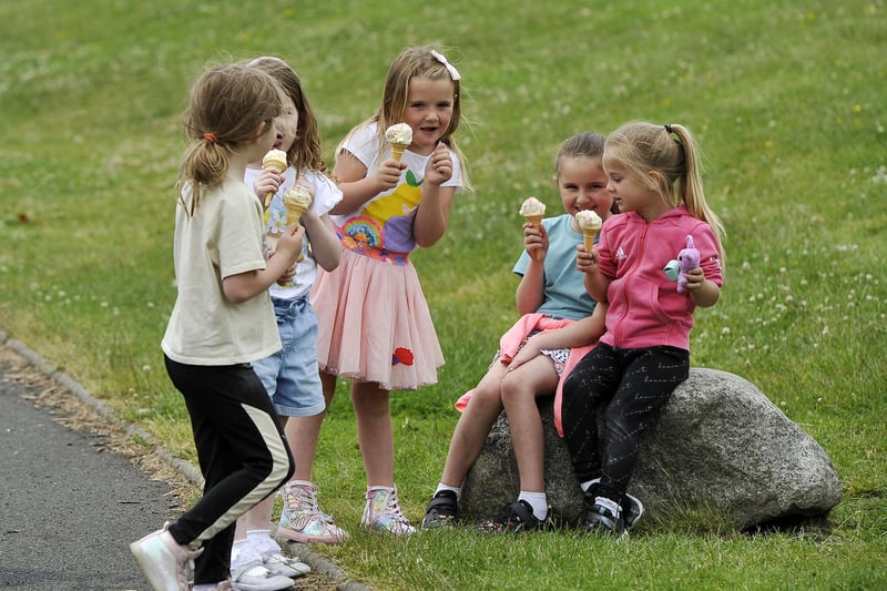Stenhousemuir schoolchildren made the most of Father John McInnes' visit by tucking into ice cream and playing games outside. Picture: Michael Gillen.