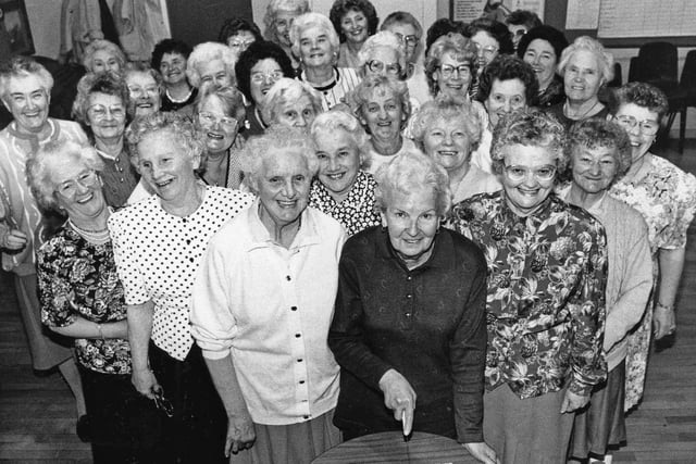 Treasurer Anne Clifford cuts the cake to celebrate the tenth birthday of Rossmere Ladies Club in May 1993.