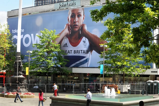 Workers installing a giant banner with photograph of Sheffield athlete Jess Ennis in celebration and support of the 2012 London Olympic Games on the John Lewis Store in Sheffield on July 23, 2012