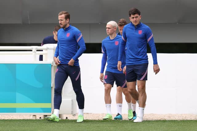 Harry Kane, Phil Foden and Harry Maguire of England walk onto the pitch prior to the England Training Session at St George's Park on June 17, 2021 in Burton upon Trent, England. (Photo by Catherine Ivill/Getty Images)