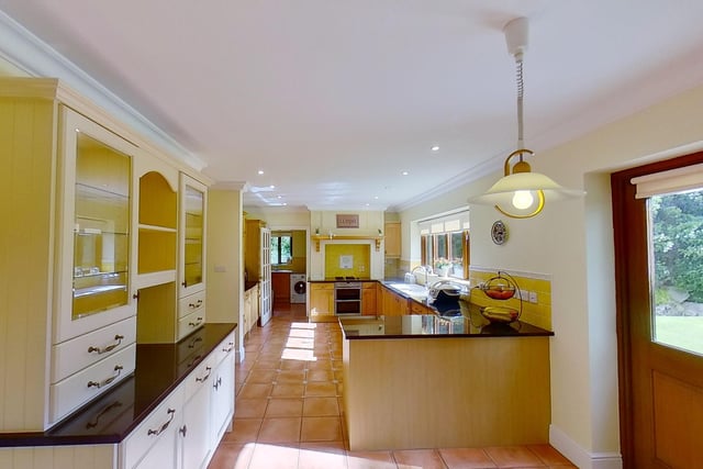 The fitted breakfast kitchen has integrated appliances and a separate dining room.