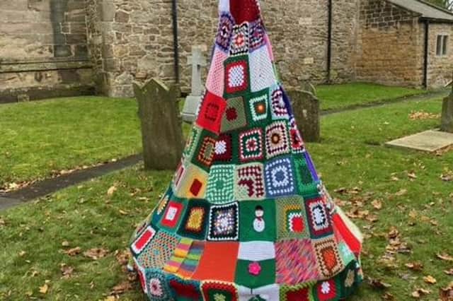 One of the four handmade knitted Christmas trees made by the Kiveton knitting and Crochet group in Sheffield placed outside the Church.