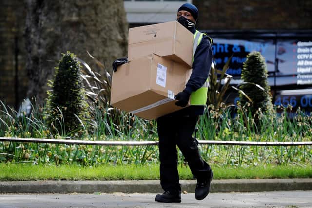A Hermes delivery courier carries boxes (Photo by Tolga AKMEN / AFP) (Photo by TOLGA AKMEN/AFP via Getty Images)