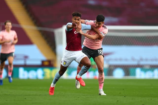 John Egan was sent off following this tussle with Aston Villa's Ollie Watkins: Clive Rose/Getty Images