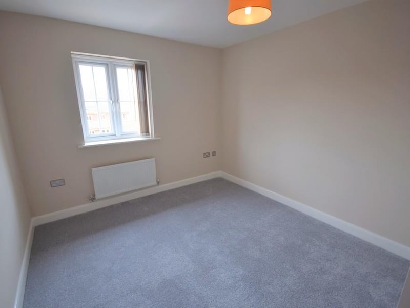 A nicely decorated bedroom having various stainless steel double socket points, radiator, modern grey carpet, UPVC double glazed window with fitted blind and an internal door to the en-suite shower room.