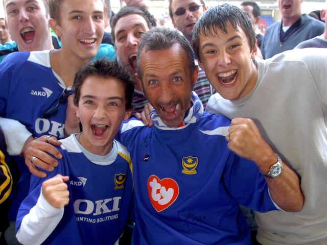 Fans on the JJB Stadium pitch can hardly believe what has happened