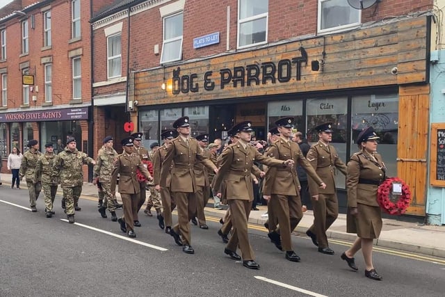 Soldiers march past the Dog and Parrot during the town's Remembrance Sunday parade.