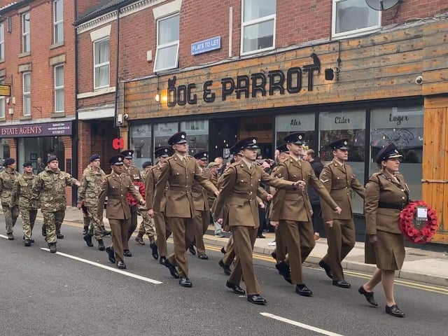 Soldiers march past the Dog and Parrot during the town's Remembrance Sunday parade.