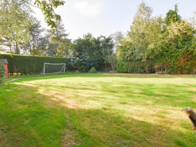 Hitting the back of the net is the back garden, which scores on appearance. A well-kept lawn is surrounded by mature trees, hedges and shrubs.