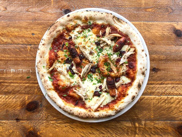 Three Joes, Fareham. Christmas Classic pizza -  British turkey, pigs in blankets, mozzarella, caramelized onion and tomato base, cranberries, sage, parsley