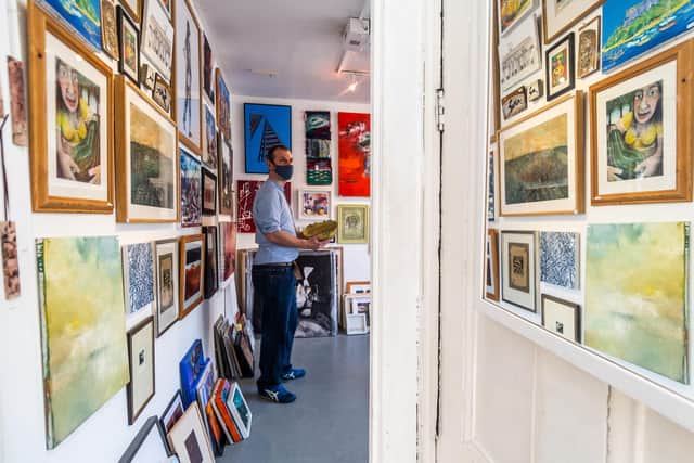 Gallery manager Graham Shapley pictured in April, setting up the Cupola Gallery's famous yearly Under The Bed Sale, where artists sell their older and early work for bargain prices, starting at under £1