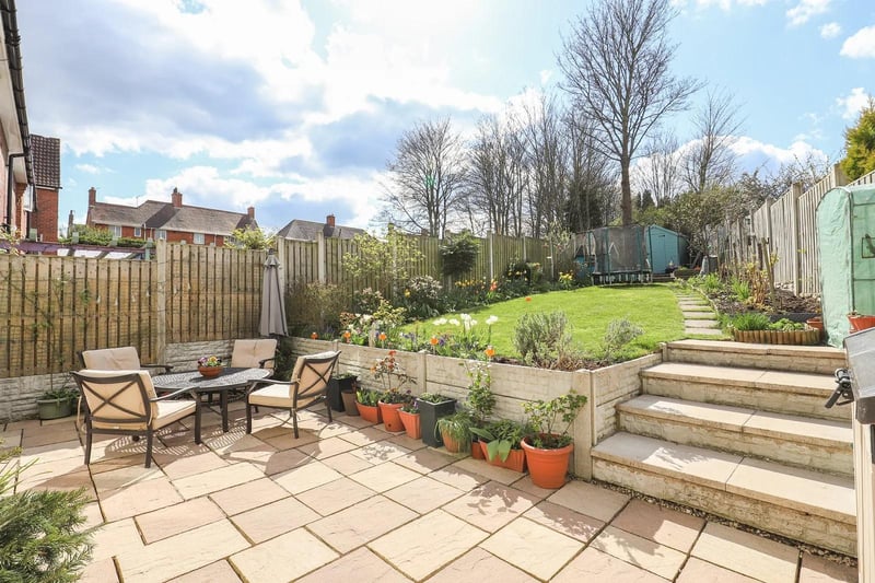 Landscaped rear garden with lawn and patio area.