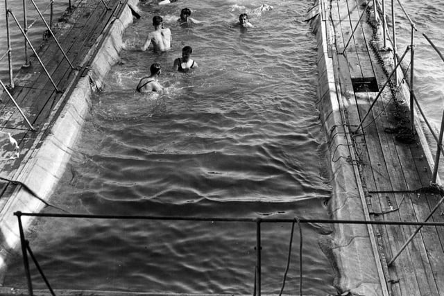 20th August 1936:  St Clement Danes Sea Cadets enjoying a swim in the floating swimming pool alongside the battleship 'Implacable', Portsmouth, where they are based for a fortnight's training.  (Photo by E. Dean/Topical Press Agency/Getty Images)