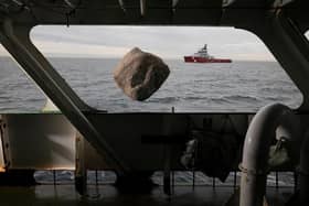 A boulder falls into the English channel from the Greenpeace ship, Esperanza with the Marine Management Organisation Fisheries Patrol boat seen in the background.
Inert granite boulders were being placed into the English Channel as part of a new bottom trawler exclusion zone in the Offshore Brighton Marine Protected Area.
The initiative will help prevent destructive bottom trawling which destroys the Offshore Brighton Marine Protected Area's protected seabed.