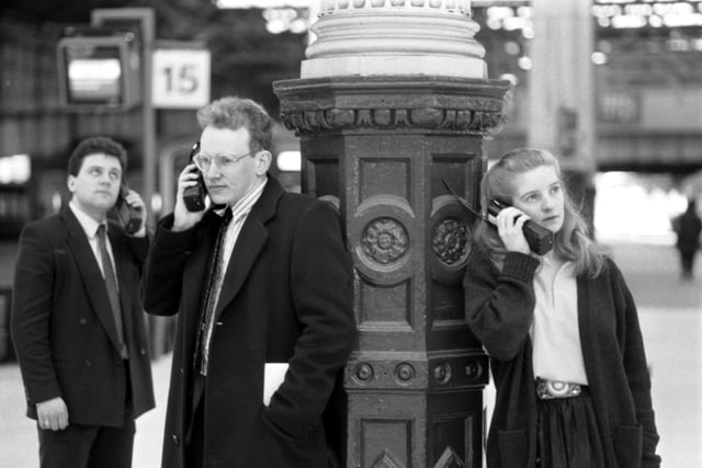 Business people - 'yuppies' - using mobile phones at Waverley station in Edinburgh, January 1990.
