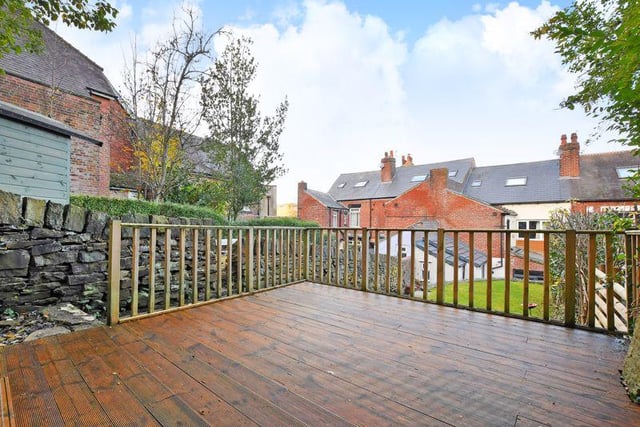 The rear garden is south-facing and has a flagged terrace with steps to a level lawn that has an adjoining decked terrace. The decking adjoins the old quarry with woodland, and a shed is included in the sale.