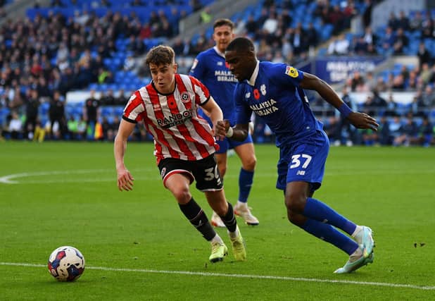 Sheffield United's Oliver Arblaster (left) and Cardiff City's Niels Nkounkou during the Sky Bet Championship match at Cardiff City Stadium, Cardiff: Simon Galloway/PA Wire.