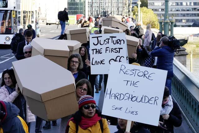 Demonstrators protesting against smart motorways march with coffins across Westminster Bridge to Parliament Square in London. Picture date: Monday November 1, 2021. PA Photo. See PA story TRANSPORT Smart. Photo credit should read: Aaron Chown/PA Wire