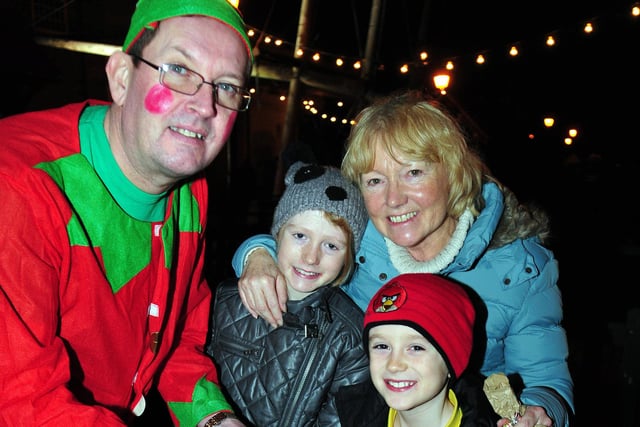 Elf Gavin Turner was helping Amy Lupton, (left) and Joseph Blackford , as well as their nana Christine Nicholson, enjoy a happy Christmas in 2013. But who can tell us where this special occasion was?